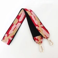 Detail of colorful geometric woven bag strap with golden lobster clasps for crossbody purses - Black Edged Pink