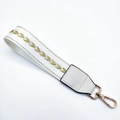 Detail of white woven bag strap with golden arrow embroidery and swivel lobster clasp - White with Gold Thread