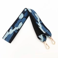 Macro shot of thick blue pixelated geometric woven strap with gold metal hooks - Black Edge Dark Blue