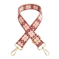 Detail of red and cream geometric embroidery on a wide crossbody strap with gold hardware - Pink with Gold Buckle