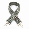 Close-up of ethnic jacquard strap with geometric patterns and golden metal clasps - No. 4 Green Base Dark Khaki