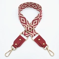 Close-up of red and white diamond patterned woven bag strap with gold metal buckles - Silver Clasp / Beige Base Wine Red + Wine Red Leather
