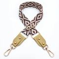 Detail of purple geometric jacquard bag strap with gold rivets and leather ends - Silver Clasp / Beige Base Purple + Khaki Leather