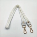 Macro detail of knitted shoulder strap with golden metal lobster clasps and leather ends - 80cm / White