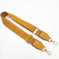 Close-up of bright yellow jacquard bag strap with gold metal hardware and leather ends - Yellow