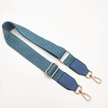 Macro view of blue maze pattern woven bag strap with golden metal hook details - Lake Blue