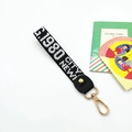 Street style woven wristlet lanyard keychain with black strap and gold metal hardware - White Letters