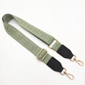 Detail of adjustable sage green woven bag strap with golden buckles and black leather ends - Matcha Green