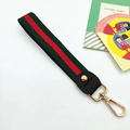 Detail of green and red striped canvas wristlet strap with gold metal lobster clasp - Green Red Green
