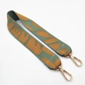 Macro detail of ethnic green leopard print bag strap with polished gold metal lobster clasps - Green Brown Elephant
