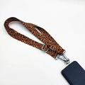 Detail of leopard print crossbody phone strap with durable metal buckle and lobster clasp - Leopard Print