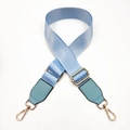 Detail of light blue nylon bag strap with gold metal hardware and green leather reinforcement - Lake Blue / Gold Buckle
