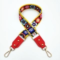 Macro detail of adjustable floral embroidered bag strap with golden rivets and red leather end - Colorful Flowers + Red Leather