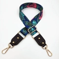 Detail of adjustable floral bag strap with gold metal hardware and brown leather - Blue Background Flowers + Black Leather