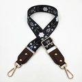Detail of adjustable floral bag strap with gold rivets and swiveling lobster clasps - Black & White Flowers + Coffee Leather