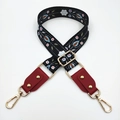 Detail of adjustable floral embroidery bag strap with leather ends and golden metal hooks - Black White Flower + Wine Red Leather