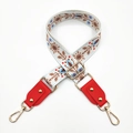 Detail of embroidered floral bag strap with red leather ends and gold metal studs - White & Brown Flowers + Red Leather