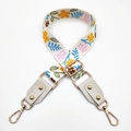 Detail of adjustable floral strap with golden lobster clasps and metal rivets - Silver Clasp / Beige Pastoral Floral/Grey Leather
