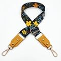 Detail of adjustable floral bag strap with mustard leather ends and gold metal hooks - Black & Yellow Flowers + Yellow Leather