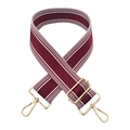 Close-up of wine red woven wide bag strap with white stripes and gold lobster hooks - Burgundy