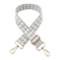 Macro detail of houndstooth jacquard shoulder strap with premium gold metal lobster clasps - Gold Buckle / Light Gray