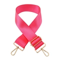 Macro view of adjustable pink nylon handbag strap with high-gloss gold hardware and texture - Barbie Pink