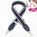 Close-up of adjustable woven shoulder strap with blue chevron pattern and gold hardware - Dark Blue