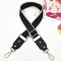 Close-up of ethnic style wide bag strap with rivets and golden lobster clasps - Gold Buckle / Black With Beige Edge