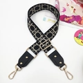 Close-up of geometric woven replacement strap with gold rivets and rotating swivel hooks - Gold Buckle / Black Mesh