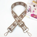 Detail of embroidered geometric pattern and golden metal buckles on adjustable bag strap - Gold Buckle / Snowflake Dark Brown
