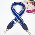 Detail of adjustable blue geometric woven bag strap with gold metal buckles and swivel hooks - Sapphire Blue