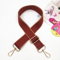 Macro shot of adjustable burgundy wide bag strap with gold metal lobster clasps - Gold Buckle / 3-Wine Red with Brown Edge