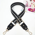 Close-up of ethnic style woven bag strap with white chevron pattern and gold rivet detail - Black White Arrow