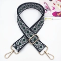 Close-up of ethnic geometric jacquard bag strap with pale gold metal lobster clasps - Diamond Black Green