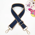 Detail of adjustable navy blue nylon handbag strap with gold metal lobster clasps - Navy Blue With Brown Edges