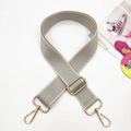 Detail view of woven shoulder strap with adjustable golden metal buckles on white background - Light Gray