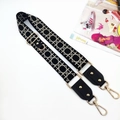 Detail of adjustable geometric weave strap with gold swivel hooks and leather trim - Grid Black Strap