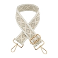 Macro detail of 5cm diamond jacquard bag strap with polished gold lobster clasps - White Border Beige