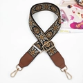 Close-up of ethnic style wide guitar strap with floral pattern and gold metal buckles - Gold Buckle / Black Brown + Brown Leather