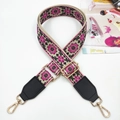 Close-up of ethnic embroidered bag strap with floral patterns and golden metal clasps - Gold Buckle / Rose Pink + Black