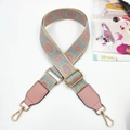 Detail of colorful jacquard bag strap with pink leather ends and golden metal hardware - Gunmetal Buckle / Pink Light Blue Webbing And Pink