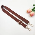 Close-up of brown adjustable cotton canvas strap with gold metal hardware and snap hooks - Brown