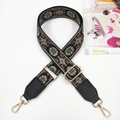 Detail of bohemian floral embroidery strap with golden metal hooks and leather ends - Gunmetal Buckle / Powder Green Webbing And Black