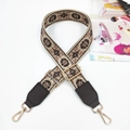Close-up of ethnic floral woven bag strap with brown leather and gold swivel hooks - Gunmetal Buckle / Powder Coffee Webbing And Coffee