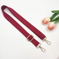 Close-up of burgundy canvas bag strap with golden metal lobster clasps and tulips - Burgundy