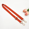 Detail of orange adjustable canvas bag strap with golden metal hooks and fine twill weave - Gold Buckle / Orange
