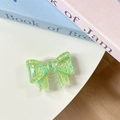 Close-up of a green glitter bow phone grip with heart sequins on a desk setup - Green Sugar Heart (Large Bow Stand)