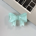 Detail of mint green bow phone grip with silver glitter on a laptop keyboard - Large Bow Grip-Dot Glitter-Green