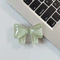 Close-up of light green glittery bow phone grip stand on laptop keyboard - Large Bow Grip-Dot Glitter-Dark Green