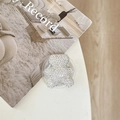 Detailed view of a sparkling rhinestone bear-shaped phone grip on a white surface - Starry Epoxy Full Rhinestone Bear / White